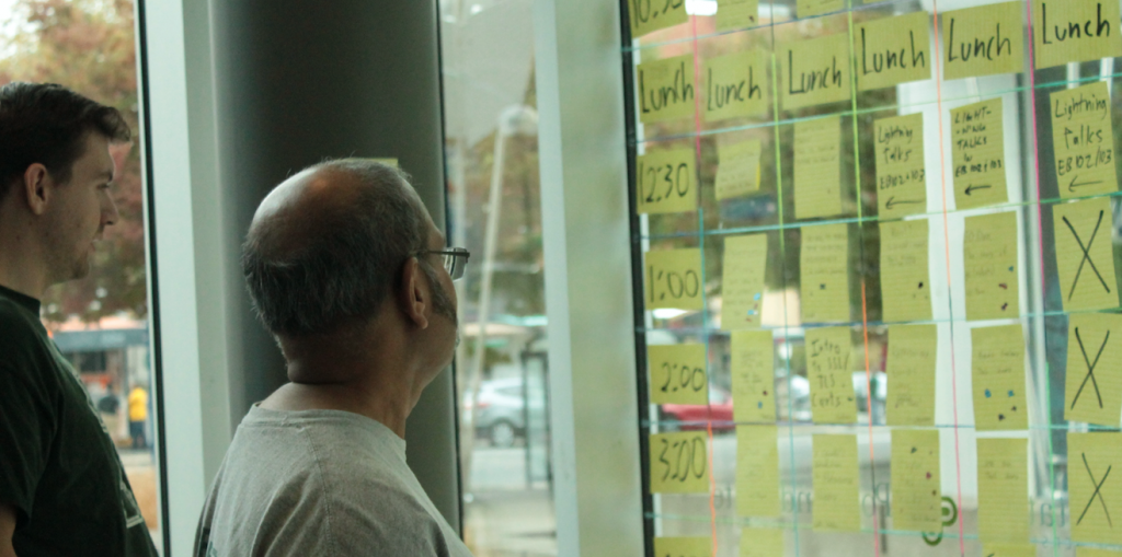participants looking at schedule postits